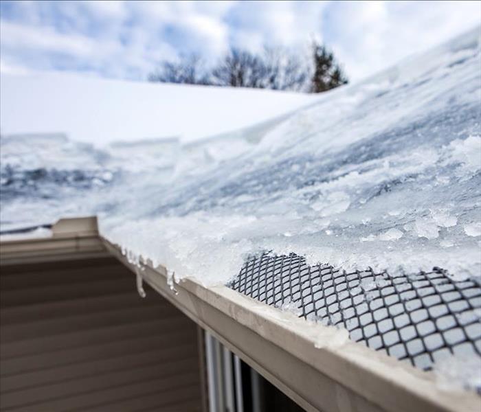 ice and snow stacked on a frozen roof
